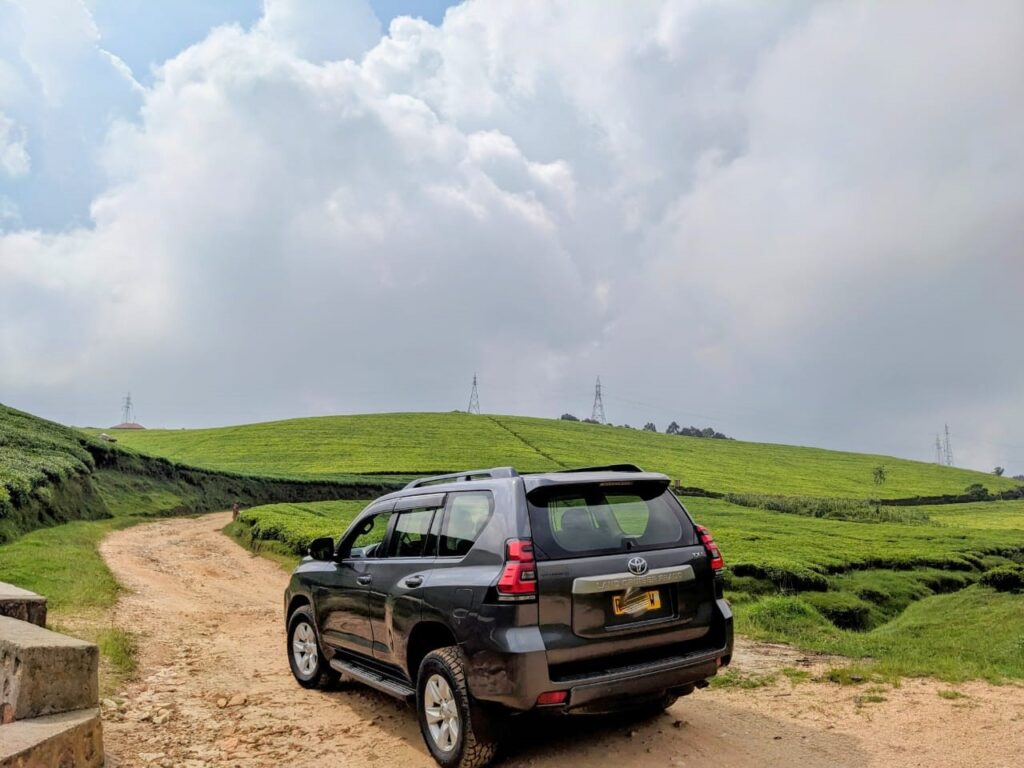 Happy traveler enjoying the freedom of self-drive car rental in Rwanda.